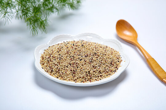 Mixed tri-color quinoa grains in blue ceramic plate