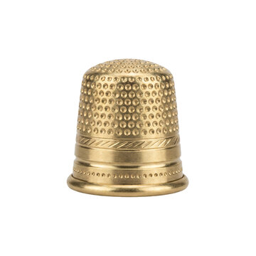 Small brass sewing thimble with a dimpled domed cap, a rolled rim and an engraved decorative band, isolated on transparent background