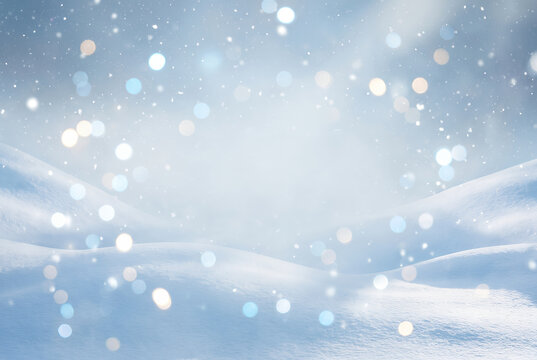 Snowy winter landscape with sparkling bokeh lights and snowdrifts