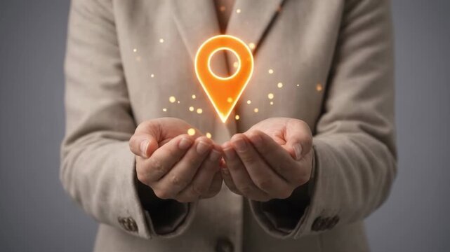 Person in suit holding cupped hands presenting glowing orange GPS map navigation location pin