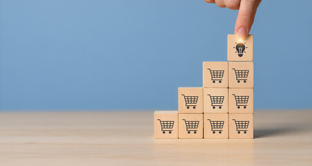 Business growth strategy and key success factor concept to increase sales volume, man holds cube with light icon symbol on many shopping cart icon  copy space. Business development for sales growth. © mystockworkc