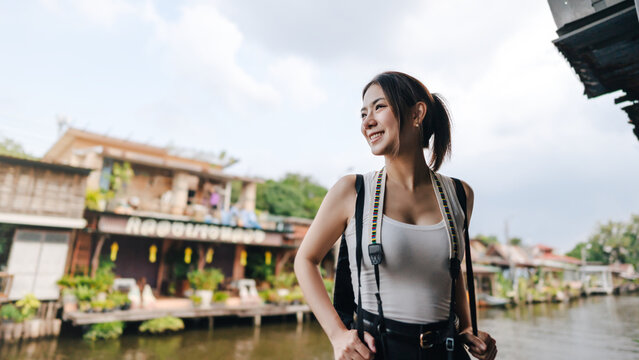 Solo female traveler enjoy travel local river settlement community exploration freedom lifestyle urban journey