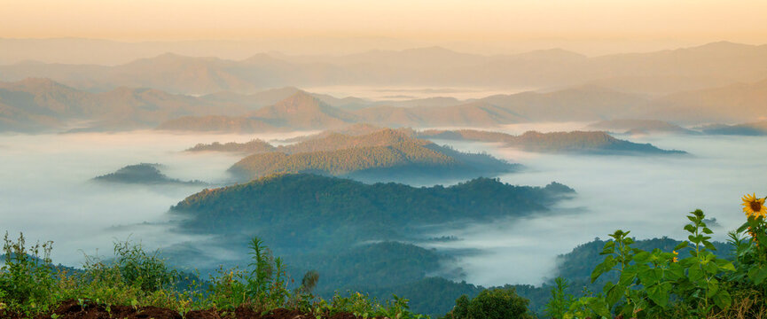 Banner Dramatic sunset mountain landscape. Banner foggy hills sun light time. panoramic Majestic green scenery big mountain hill cloudscape valley panorama view greenery country. Scenic beautiful