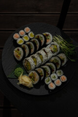 Elegant sushi platter with ginger and wasabi on a dark table © Cavan