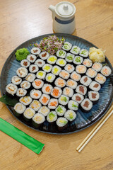 Large platter of assorted maki sushi rolls on a table © Cavan