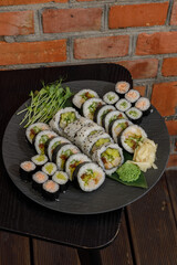 Assortment of fresh Japanese sushi rolls on a slate platter © Cavan