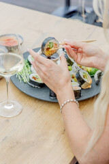 Woman dipping a sushi roll into soy sauce © Cavan