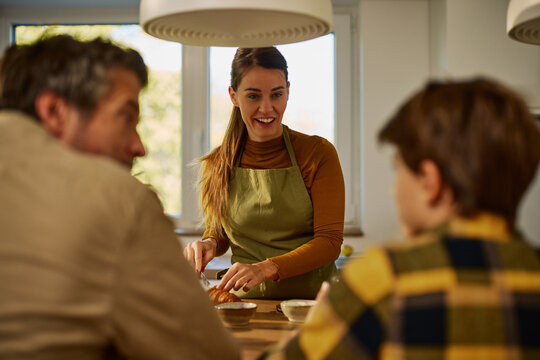 Family enjoying breakfast together at home kitchen table