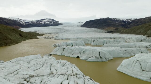 Fjallsarlon Glacier Lagoon, Hornafjordur, Oraefi, South Iceland, Iceland, shows Fjallsjokull ice front, floating ice and moraines, drone slide