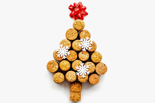 Corks of wine bottles in shape of new year spruce on white background top view copyspace