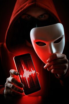Person in disguise holds illuminated smartphone displaying sound waves.