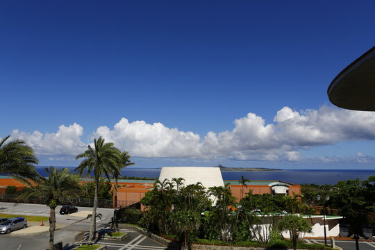 Tropical resort and ocean view under blue sky.