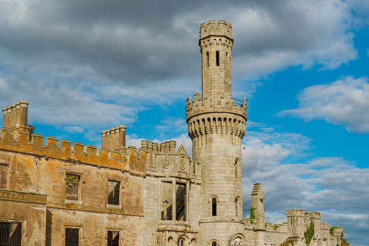 Abandoned castle ruins against a cloudy blue sky