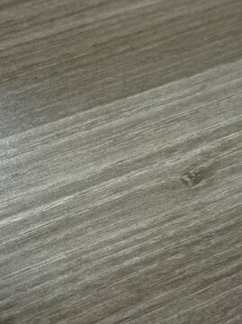 Dark gray wood grain texture with natural lines and knot, matte surface