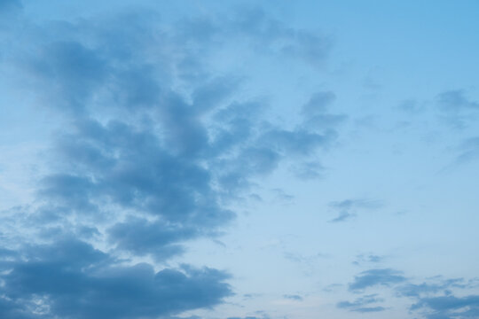 Stratocumulus clouds in a pale blue sky during the day