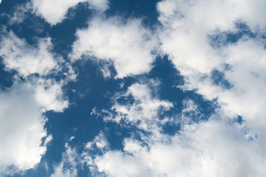 Cumulus fractus clouds against a deep blue sky