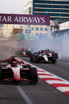 BAKU, AZERBAIJAN - SEPTEMBER 2026: Pack of Formula 2 cars racing along the main straight past the overhead gantry at the Azerbaijan Grand Prix