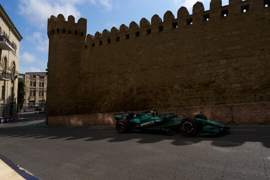 BAKU, AZERBAIJAN - SEPTEMBER 2026: Aston Martin Aramco F1 Team car races alongside the ancient Old City fortress wall during the Azerbaijan Grand Prix