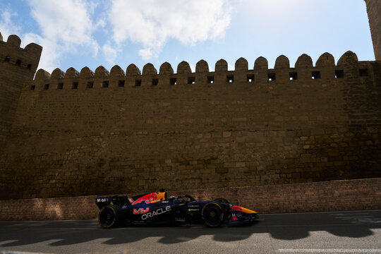BAKU, AZERBAIJAN - SEPTEMBER 2026: Oracle Red Bull Racing F1 Team car speeds alongside the ancient Old City fortress wall during the Azerbaijan Grand Prix
