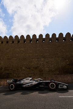 BAKU, AZERBAIJAN - SEPTEMBER 2026: Cadillac F1 Team car speeds alongside the ancient Old City fortress wall during the Azerbaijan Grand Prix
