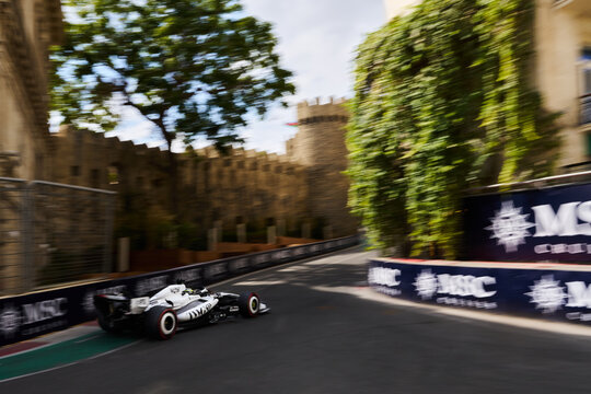 BAKU, AZERBAIJAN - SEPTEMBER 2026: Cadillac F1 Team car speeds along the Baku City Circuit near the historic Old City castle wall during the Grand Prix