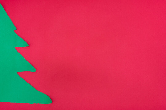 Green Torn Paper Christmas Tree on Red Background