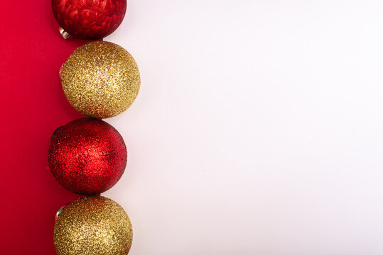 Red and Gold Christmas Ornaments on Red and White Paper Background