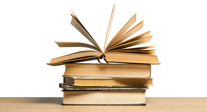 Stack of books with an open book on top placed on a wooden table