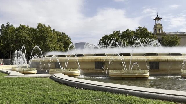 Barcelona, Spain, August 13, 2026 -The Magic Fountain of Montjuic (Font Magica de Montjuic) on a sunny day, featuring its monumental circular basin and surrounding architecture at the foot of Montjuic