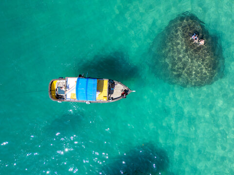 Aerial View of Boat and Swimmers in Turquoise Waters at Lago Azul, Brazil