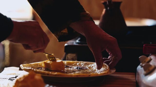 The process of making Traditional Balkar khychin, a thin stuffed flatbread from the North Caucasus, being prepared and cooked in a kitchen in slow motion video. Balkar cuisine and traditional food..