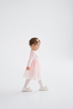Toddler Girl Walking on White Background in Studio