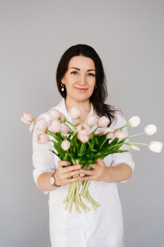 Smiling Medical Professional Woman Holding Spring Bouquet