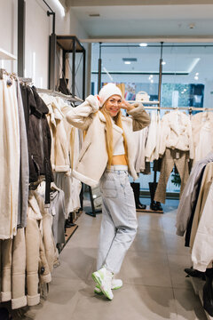 Shopping Woman Adjusting White Hat in Store