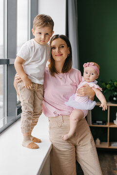 Front View Portrait of a Mother with two Children in a Studio