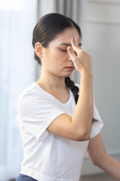 Women fitness yoga, Peaceful Asian woman practicing pranayama yoga breathing exercise at home. Yoga lifestyle concept.