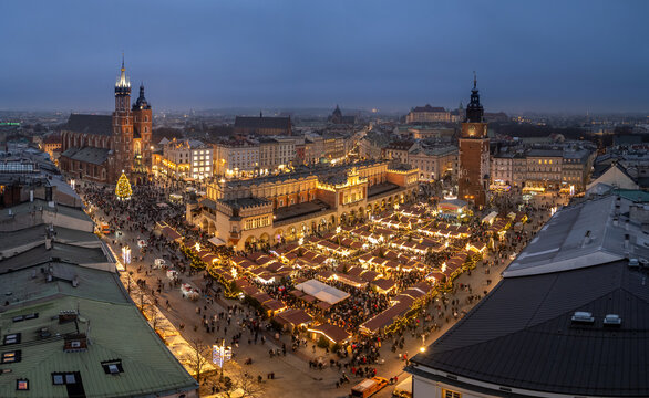 Krakow, oland, evening aerial view of illuminated Main Square with Christmas Fairs crowded with people