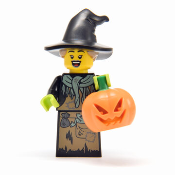 L&ouml;rrach, Germany - Oktober 13th 2026: Lego minifigure cute halloween witch in hat with orange pumpkin jack lantern. Editorial illustrative image of religious holiday or popular children toy.