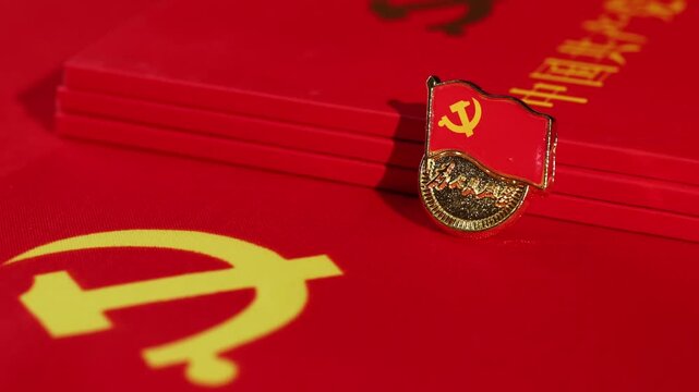 Blurred Red Flag with Golden Symbols and Pin