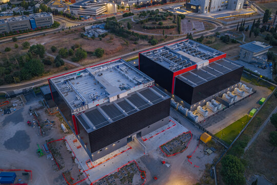 Aerial view of Aruba Hyper Cloud Datacenter IT4 with modern industrial buildings, cooling units on rooftops, and surrounding infrastructure in Roma, Lazio, Italy.