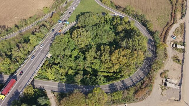 Aerial View of a Highway Interchange: An overhead perspective captures a complex highway interchange with vehicles navigating its intricate network of roads.