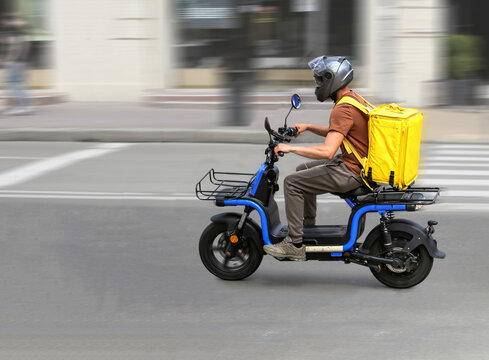 Abstract image of a courier on a motorcycle on a blurred background