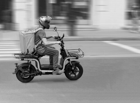 Abstract image of a courier on a motorcycle on a blurred background