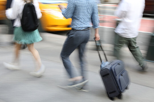 A young man with a suitcase on a journey