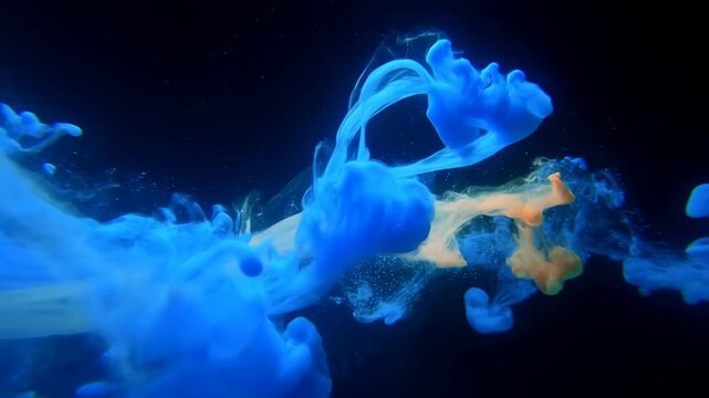 Blue and orange ink clouds swirl and diffuse through a dark liquid environment. Motion graphics, title sequence, and creative advertising.