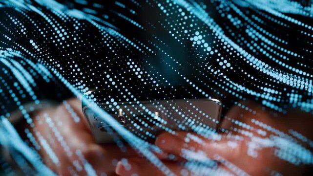 A person is using a smartphone at night. Bright lines of data are flowing around the phone, creating a digital effect. The scene shows a blend of technology and user interaction.