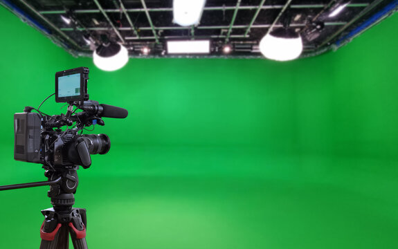 Green screen filming studio with video camera for banner with copy space