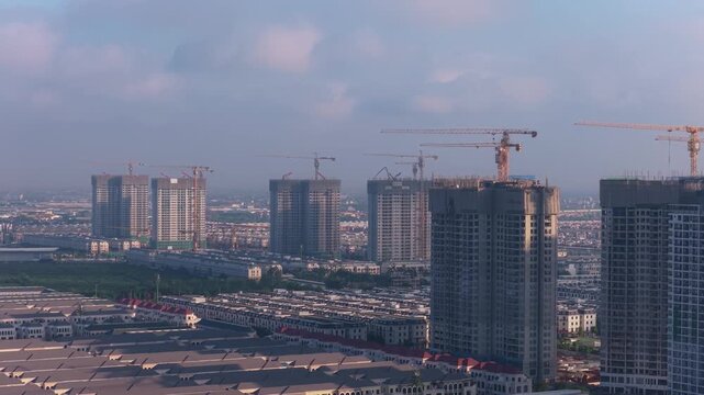 Sunrise over a rapidly developing asian city construction site