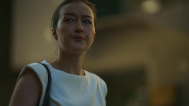 A young woman uses her smartphone, looking confused and thoughtful in an urban setting. She appears to be navigating the city, perhaps lost or searching for information.