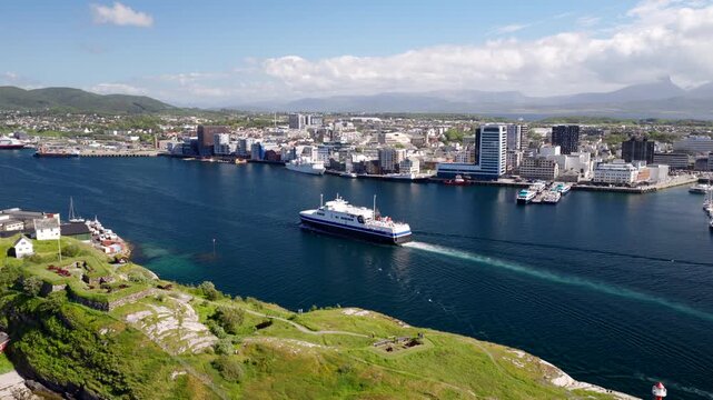 Aerial dolly view over Nyholmen of MF Landegode ferry arriving in Bodo harbor
